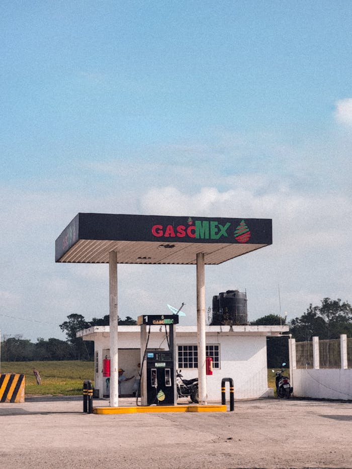 our-services-1 A small rural gas station under a clear blue sky, featuring a Gasmex sign.